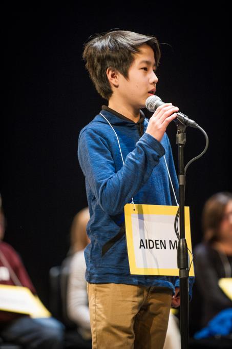 A contestant anxiously waiting for their word at the microphone