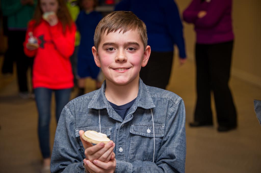 A contestant smiles for the camera before eating a spelling bee snack.