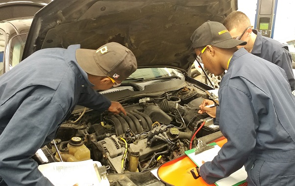 Students working on car engine