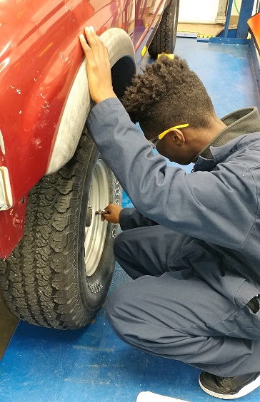 Student checking tires