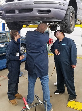 Students working on car
