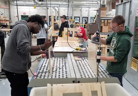 Students working on production of stand up desks