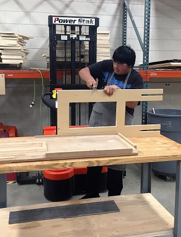 Manufacturing student working on production of stand up desk