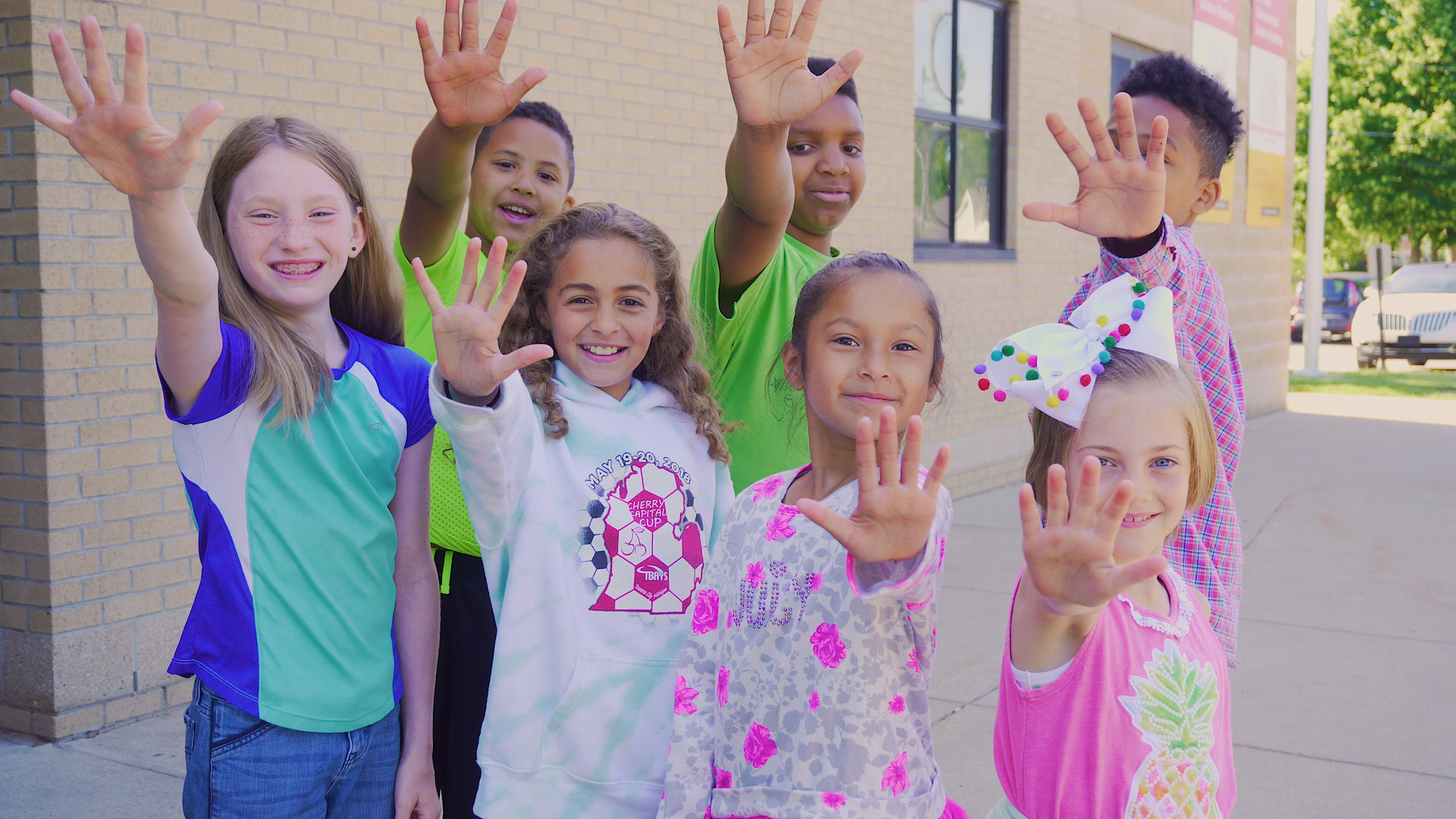 Young students encouraging others to Strive for Less Than 5 days absent